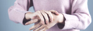 Woman with rheumatoid arthritis holding her wrist