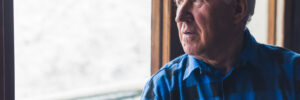 Senior citizen with dementia gazing out window