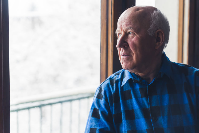 Senior citizen with dementia gazing out window