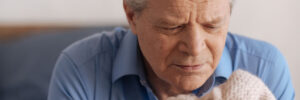 Elderly man with dementia holding blanket