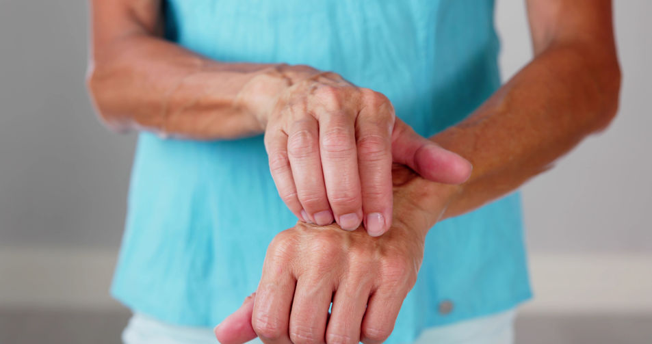 Woman holding hand due to pain from an arthritis flareup