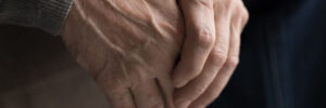 Man clenching hands as he deals with early signs he might have Parkinson's Disease