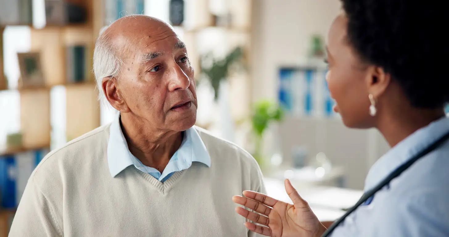 Doctor consulting with mature man at hospital